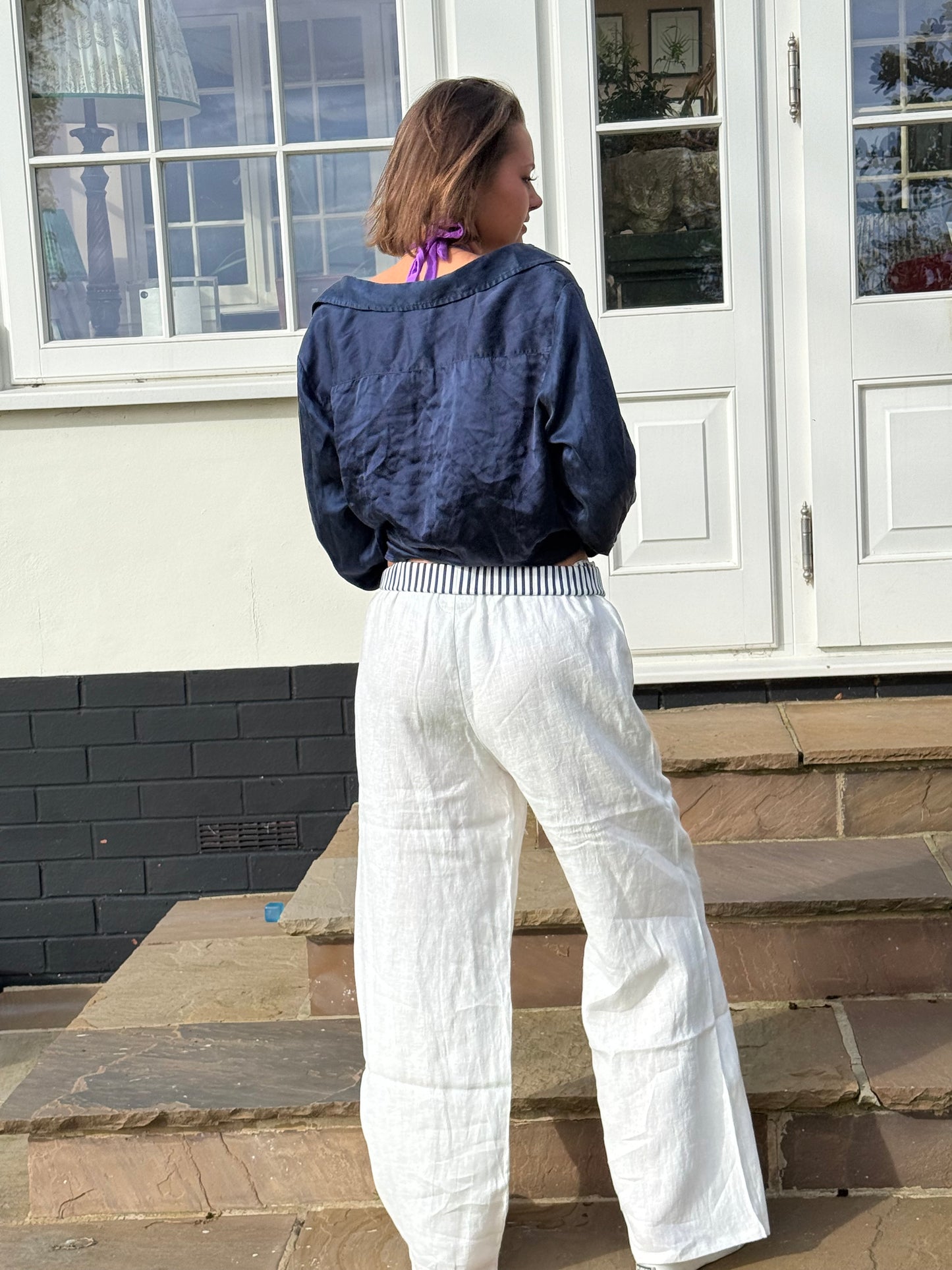 White 100% linen loose trousers with our trademark stripe waistband